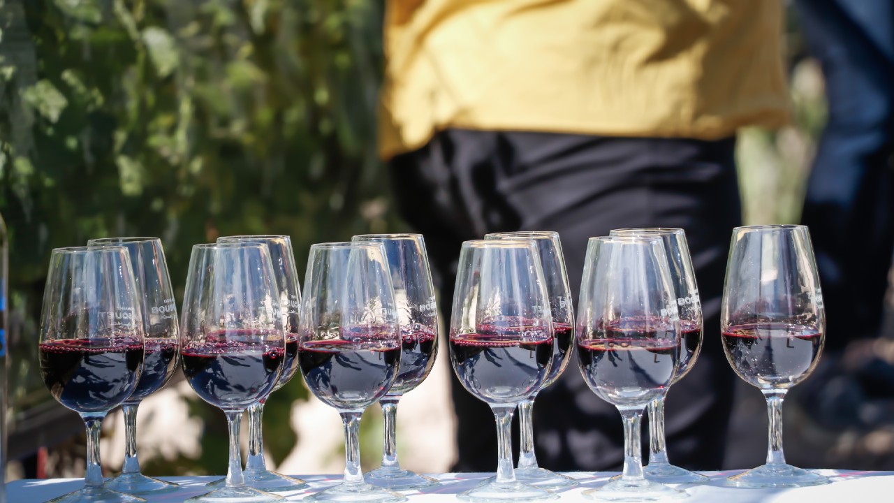 Glasses of wine laid out on a table in the wine trends of 2021