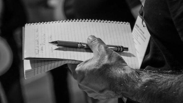 A guest takes note at a wine tasting